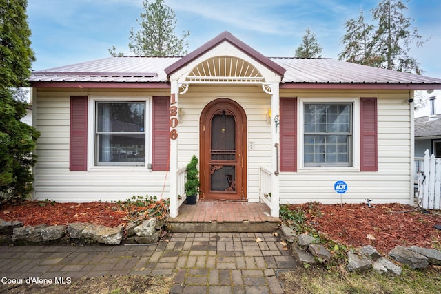 bungalow featuring metal roof