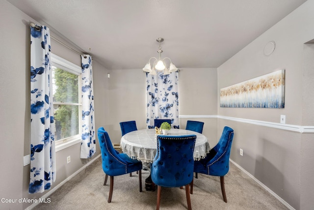 carpeted dining space featuring baseboards and a notable chandelier