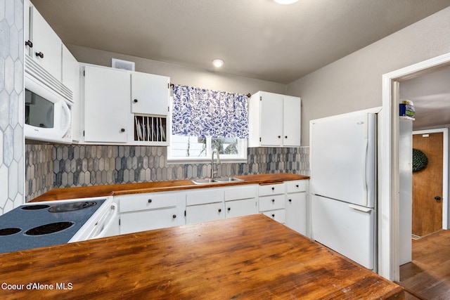 kitchen featuring tasteful backsplash, white cabinetry, a sink, wood counters, and white appliances