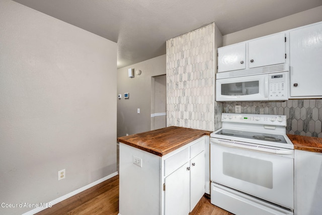 kitchen featuring white appliances, wood counters, white cabinetry, and decorative backsplash