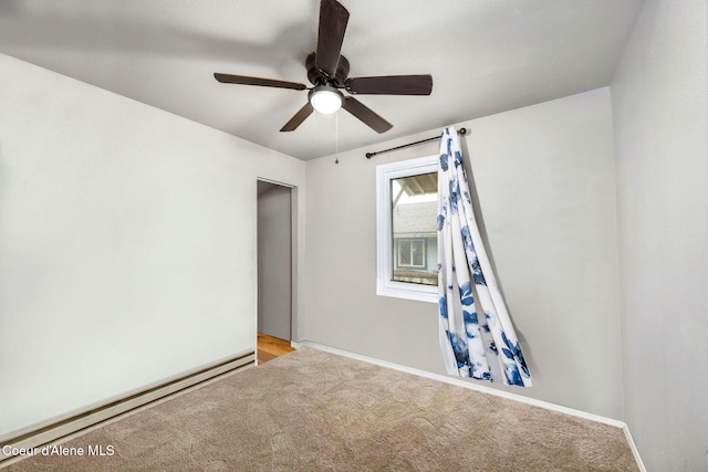 spare room with a baseboard heating unit, ceiling fan, and carpet flooring