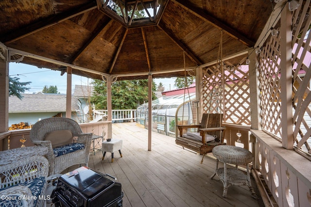 wooden terrace featuring a gazebo