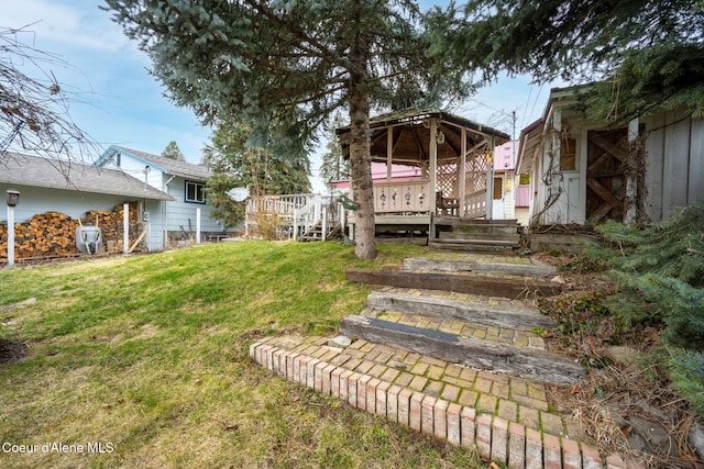 view of yard featuring a gazebo and a wooden deck