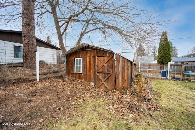 view of shed featuring fence