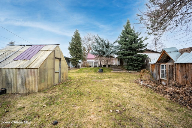 view of yard featuring an exterior structure and an outdoor structure