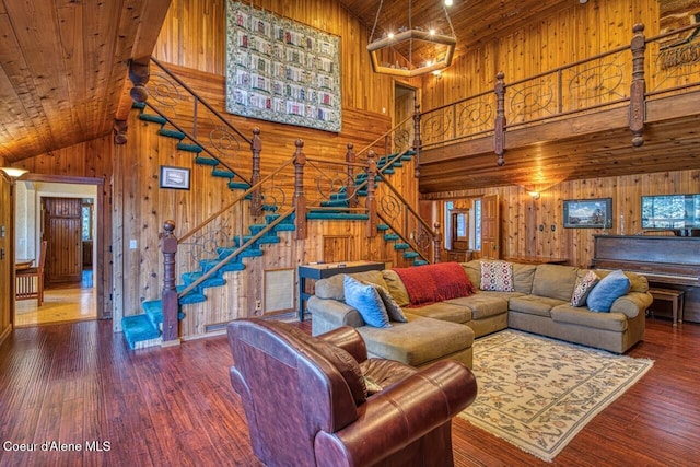 living room featuring wood walls, wood ceiling, stairs, and hardwood / wood-style flooring