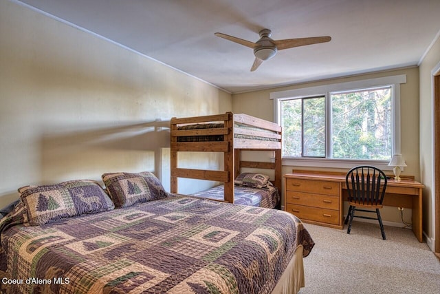 bedroom featuring light carpet, ceiling fan, ornamental molding, and baseboards