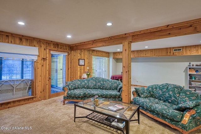 living room featuring wooden walls, visible vents, carpet flooring, and recessed lighting