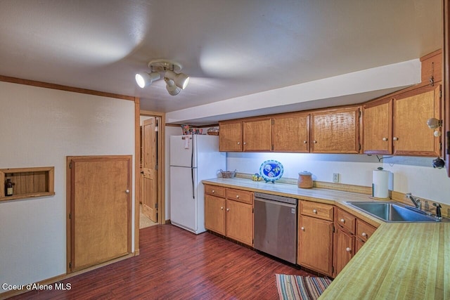 kitchen with a sink, light countertops, stainless steel dishwasher, freestanding refrigerator, and dark wood finished floors