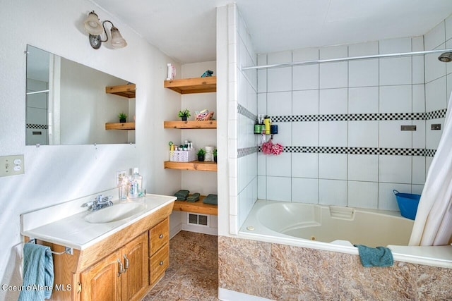 bathroom with a combined bath / shower with jetted tub, vanity, and visible vents