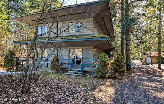 view of front of property with a porch and an outbuilding