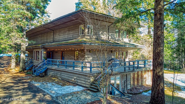 rustic home with stairway and a porch