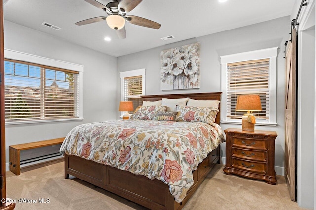 bedroom featuring light carpet, a barn door, visible vents, and recessed lighting