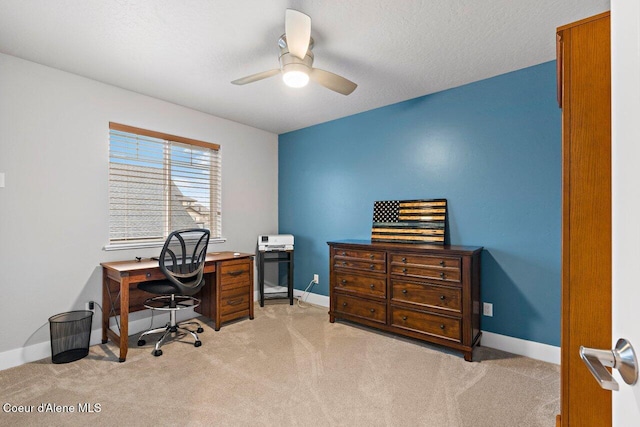 home office featuring ceiling fan, a textured ceiling, baseboards, and carpet flooring