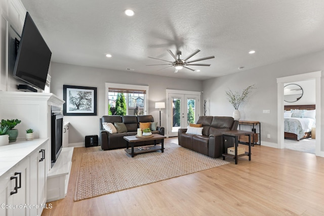 1841 W Felton Dr, Coeur Dalene, ID 83814 - living area featuring recessed lighting, a ceiling fan, a large fireplace, and light wood-style flooring