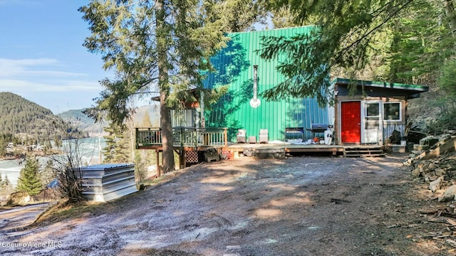 view of front of property with a deck with mountain view