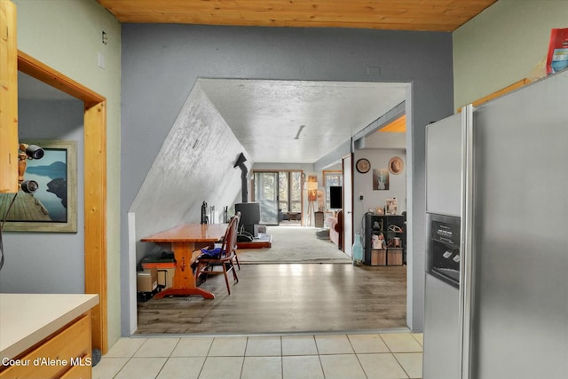 interior space with wood ceiling and light tile patterned floors