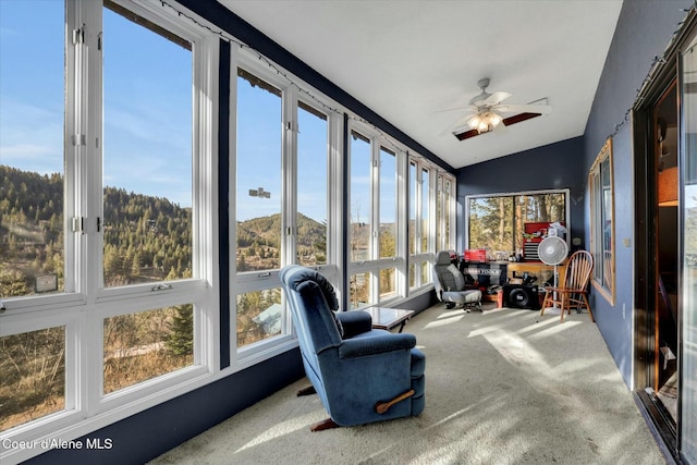 sunroom / solarium with a ceiling fan and lofted ceiling