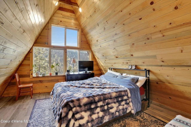 bedroom featuring vaulted ceiling, wood finished floors, wood ceiling, and wooden walls