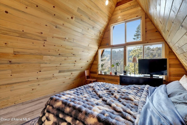 bedroom with wood walls, vaulted ceiling, and wood finished floors