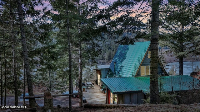 property exterior at dusk with metal roof