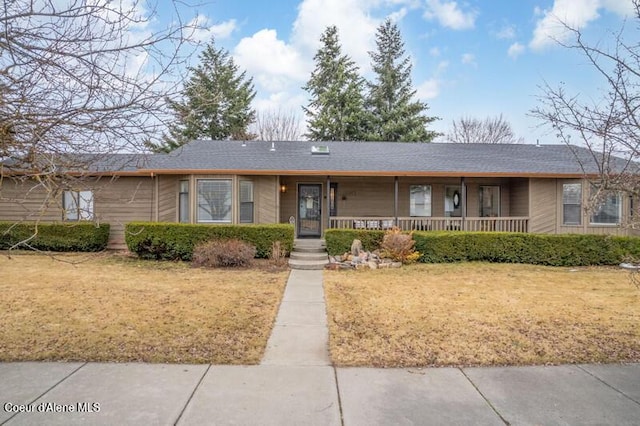 single story home with covered porch and a front lawn