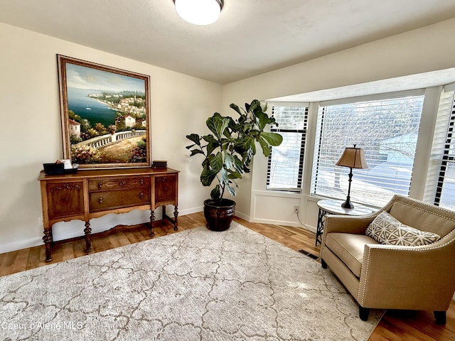 sitting room with wood finished floors and baseboards