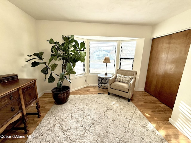 sitting room featuring baseboards and wood finished floors