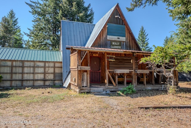 exterior space featuring an outbuilding and metal roof