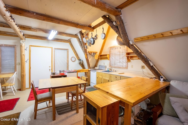 dining area with beam ceiling and a workshop area