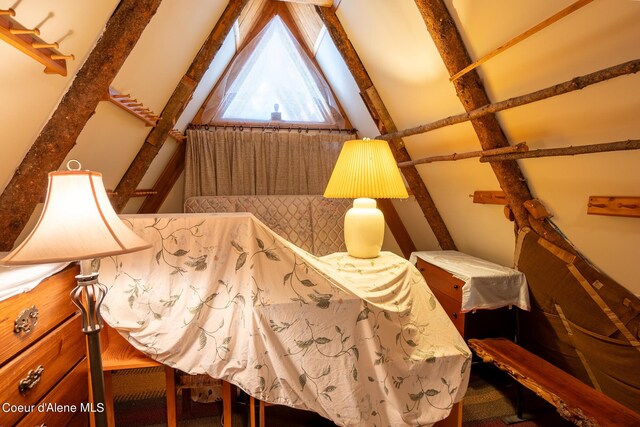 interior space with vaulted ceiling with beams