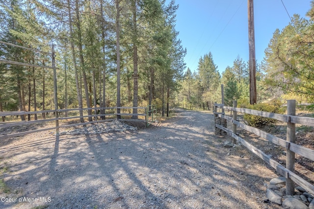 view of road with a forest view