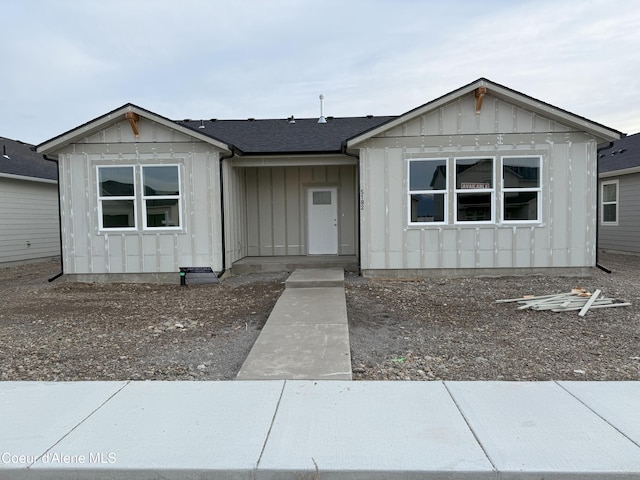 view of front facade with a shingled roof and board and batten siding