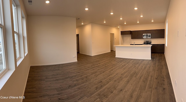 kitchen featuring appliances with stainless steel finishes, open floor plan, dark wood-style flooring, and recessed lighting