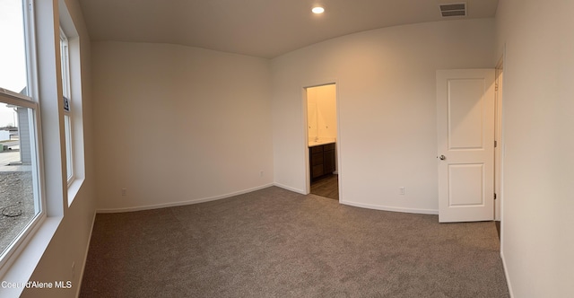 spare room with recessed lighting, dark carpet, visible vents, and baseboards