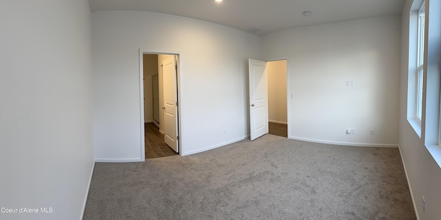 unfurnished bedroom featuring carpet floors, visible vents, and baseboards