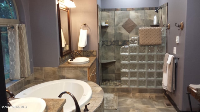 bathroom with a shower stall, a bath, and vanity