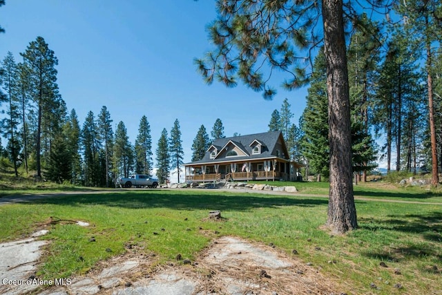 farmhouse inspired home featuring covered porch and a front lawn