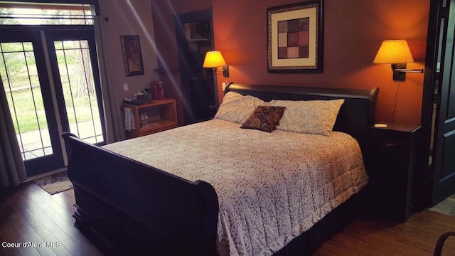 bedroom featuring dark wood-type flooring and access to exterior