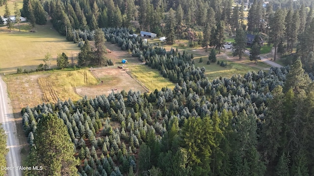 birds eye view of property featuring a wooded view and a rural view