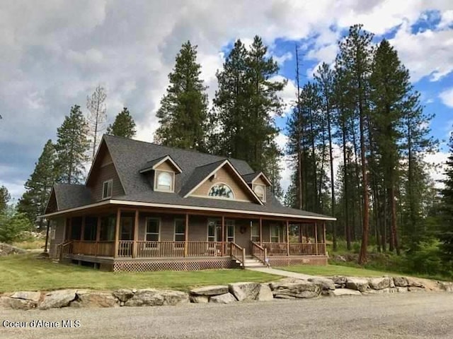 country-style home with a front yard and covered porch