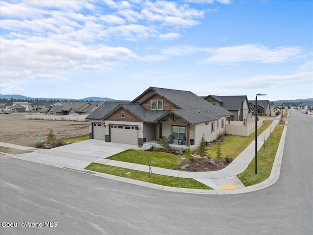 view of front of house with driveway, a residential view, an attached garage, fence, and a front lawn