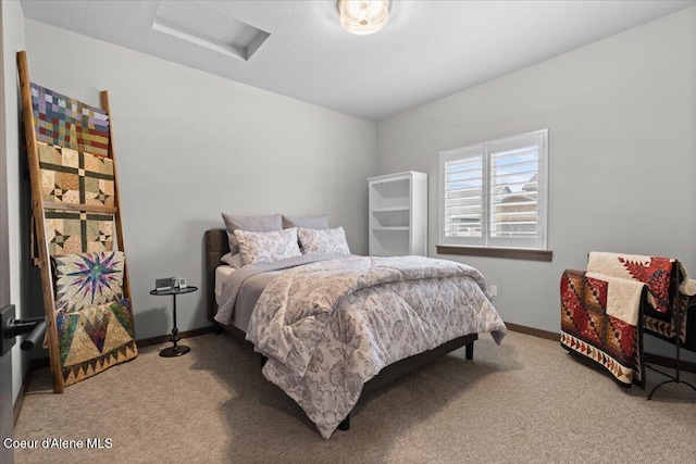 bedroom featuring attic access, carpet floors, and baseboards