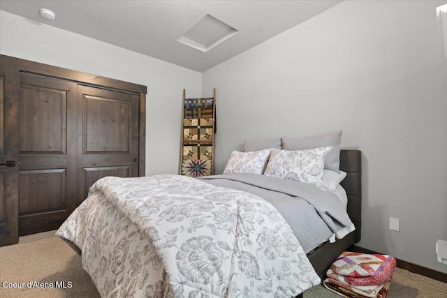 bedroom with light carpet, attic access, and baseboards