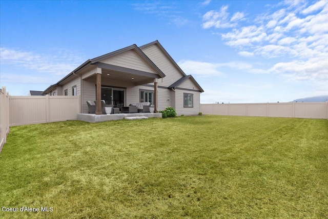 rear view of house featuring a patio area, a fenced backyard, a yard, and outdoor lounge area