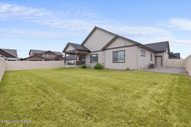 back of property featuring a yard, a fenced backyard, and cooling unit