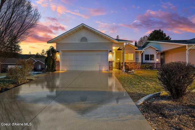 view of front facade with driveway, a garage, and a front lawn