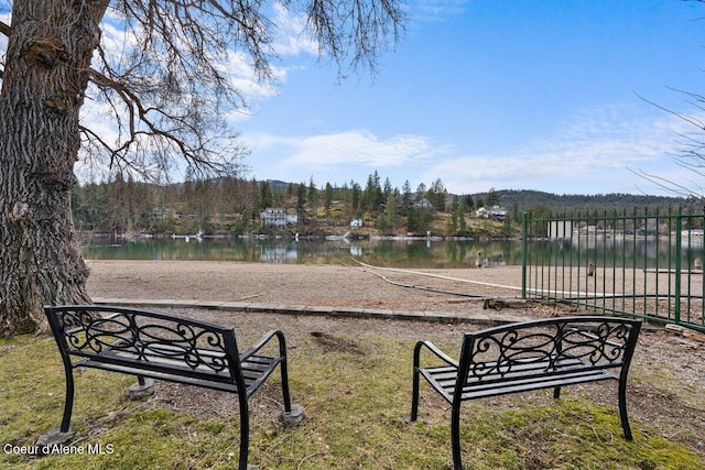 view of home's community featuring a water view and a forest view