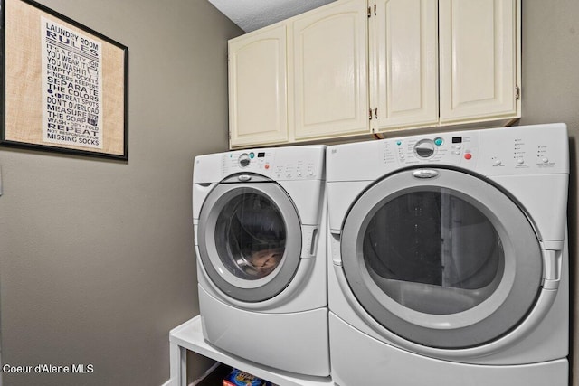 laundry area featuring washer and clothes dryer and cabinet space