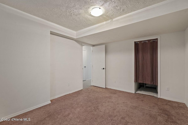 unfurnished bedroom with carpet, baseboards, and a textured ceiling